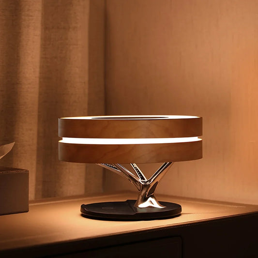 Lampe de table élégante et multifonctionnelle. Haut-parleur TWS intégré, réveil et chargeur sans fil, le tout avec un design épuré et moderne
